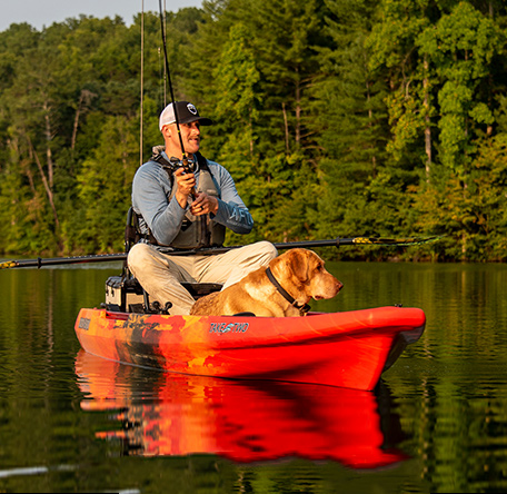 happy angler with his dog fishing in a TakeTwo kayak